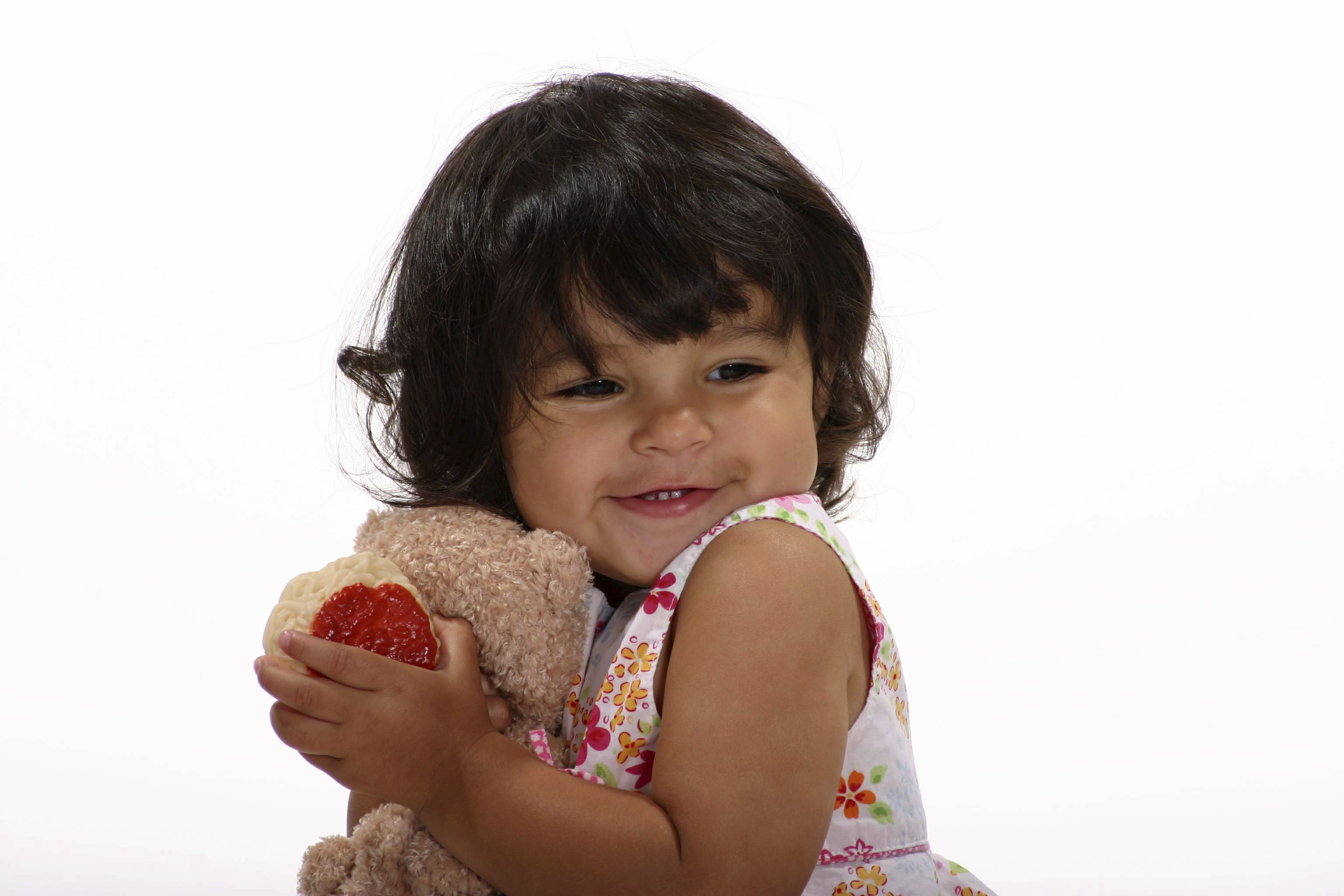 girl hugging teddy bear